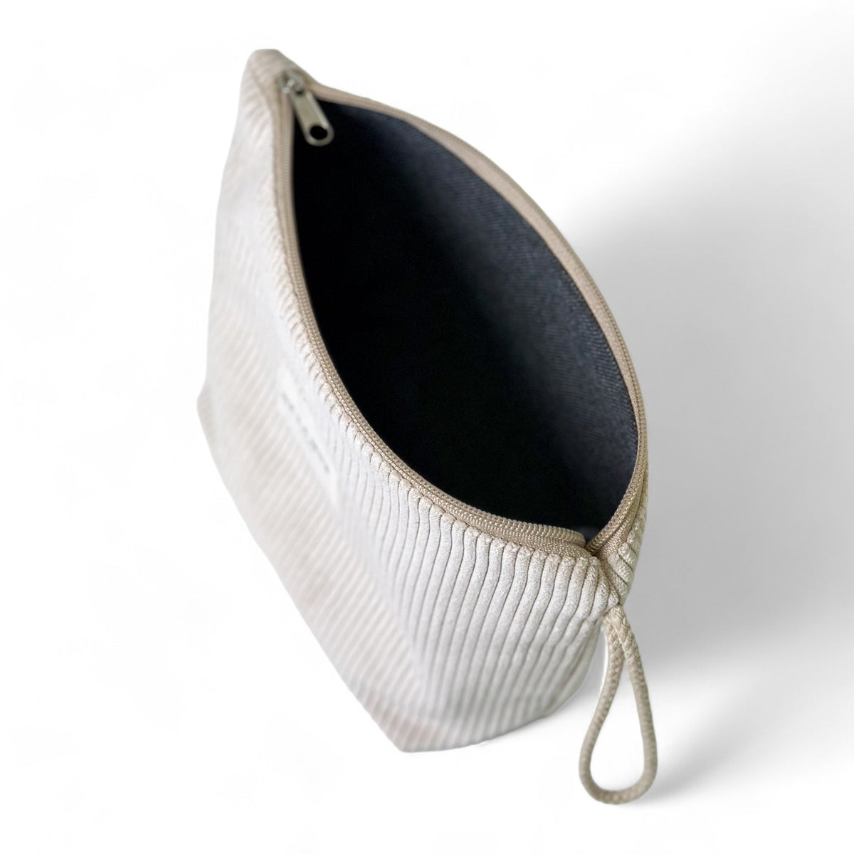 Open DE LA MUR Tofe corduroy makeup bag showing the dark lined interior